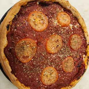 a pizza topped with tomatoes