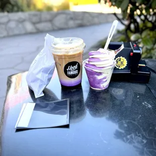 A hood famous iced ube latte and an ube/vanilla soft serve swirl in a cup.