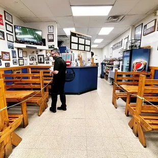 a woman standing in a sub shop