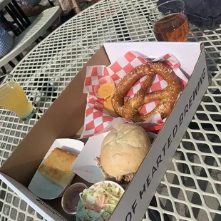 Oak hill barbecue pulled pork sandwich, coleslaw, cornbread, and house pretzel with beer cheese