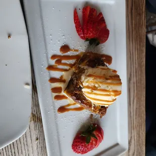Bread pudding dessert with ice cream and caramel.