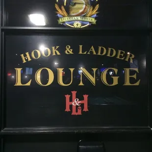 a sign for hook and ladder lounge