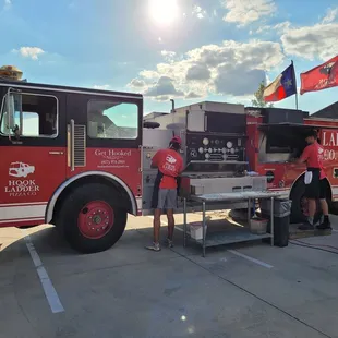 two men working on a food truck