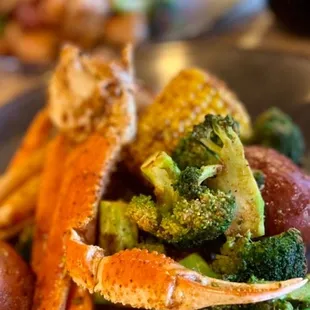 What a beautiful display of snow crab, broccoli, red potatoes, and corn on the cob!