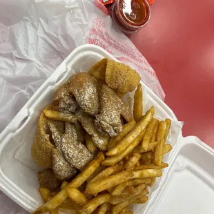 a container of fries and ketchup