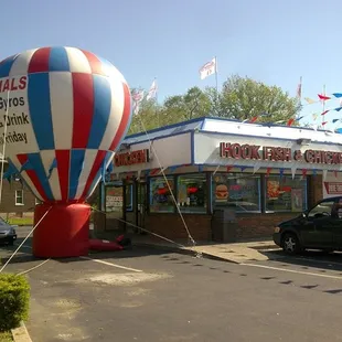 a hot air balloon in front of a restaurant