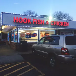 a car parked in front of a restaurant