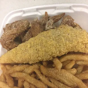 a close up of a fish and chips meal in a styrofoam container
