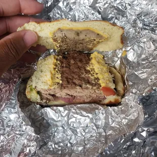 a hand holding a sandwich