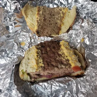 two sandwiches wrapped in tin foil