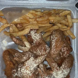 fried chicken and french fries in a styrofoam container