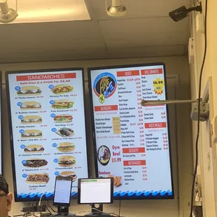 a man sitting in front of a menu