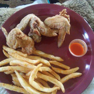Fried chicken &amp; fries, hot sauce on the side.