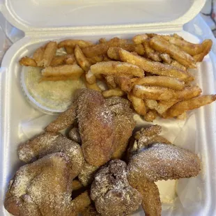 a tray of fried chicken and french fries