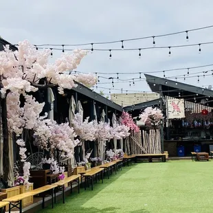 a row of tables and umbrellas with pink flowers