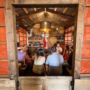 a group of people sitting in a hook room