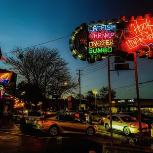 Hook Line &amp; Sinker sign at dusk
