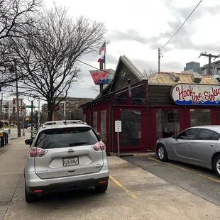two cars parked in front of a restaurant