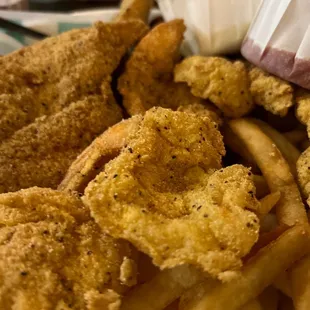 a basket of fried fish and fries