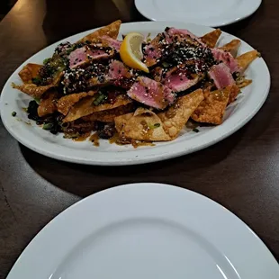 Tuna Wonton with Ahi Tuna, teriyaki sauce, scallions, seaweed, sesame seeds