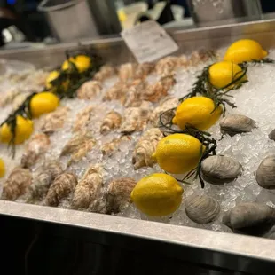 a display of clams and lemons
