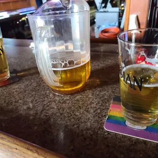 two glasses of beer on a bar