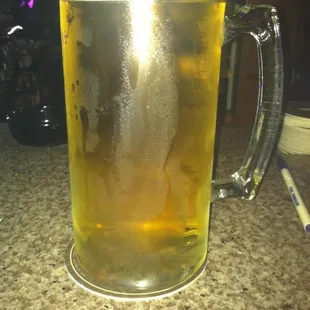 a glass of beer on a counter