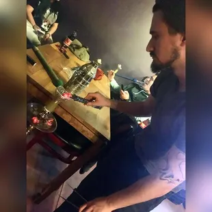 a man cutting a cake with a knife