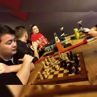 a group of people playing a game of chess