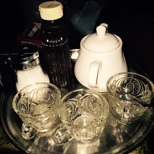 a tray of glasses and a teapot