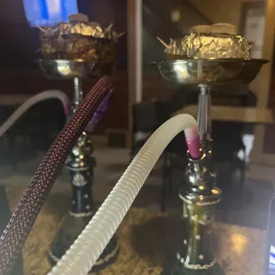 a hookah with a dollar bill in the background