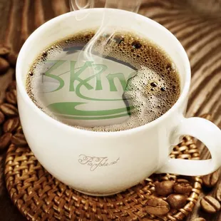 a cup of coffee with steam rising out of it