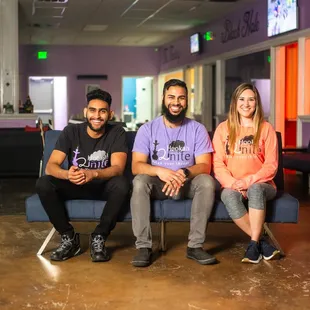 three people sitting on a couch