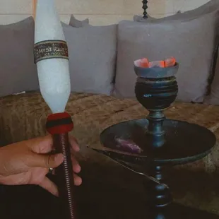 a person holding a hookah