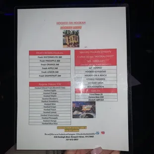 a hand holding a menu