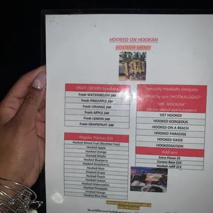 a hand holding a menu