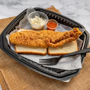 a fried fish sandwich with a side of coleslaw
