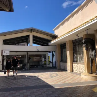 two people walking in a courtyard