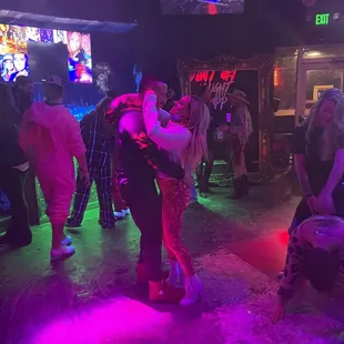 a man and a woman dancing on the dance floor