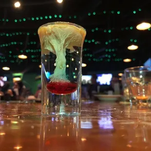 a shot of alcohol with a slice of lemon