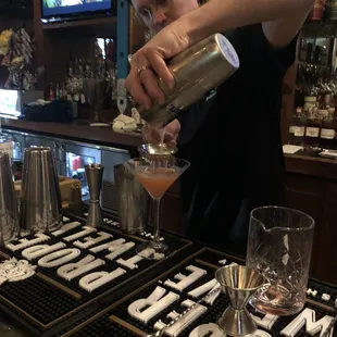 a bartender pouring a drink