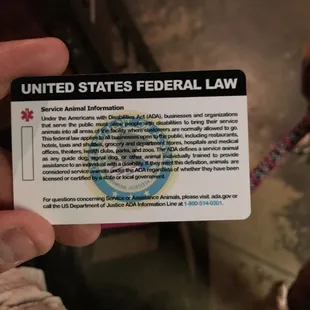 a person holding a united states federal law card