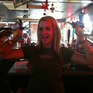 a woman holding up a beer