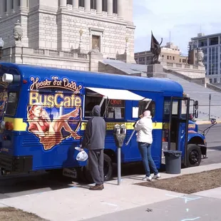 people getting on the bus