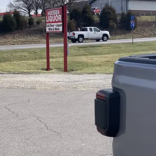 a truck parked in front of a liquor store