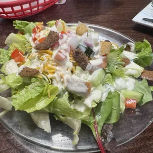 Side Salad- mixed greens with tomatoes, cucumber, onion, shredded cheese, croutons and ranch dressing.