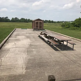 empty picnic tables in a field