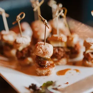 a plate of mini sandwiches