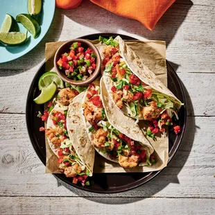 a plate of tacos and a bowl of salsa