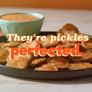 a plate of fried food with a bowl of dipping sauce
